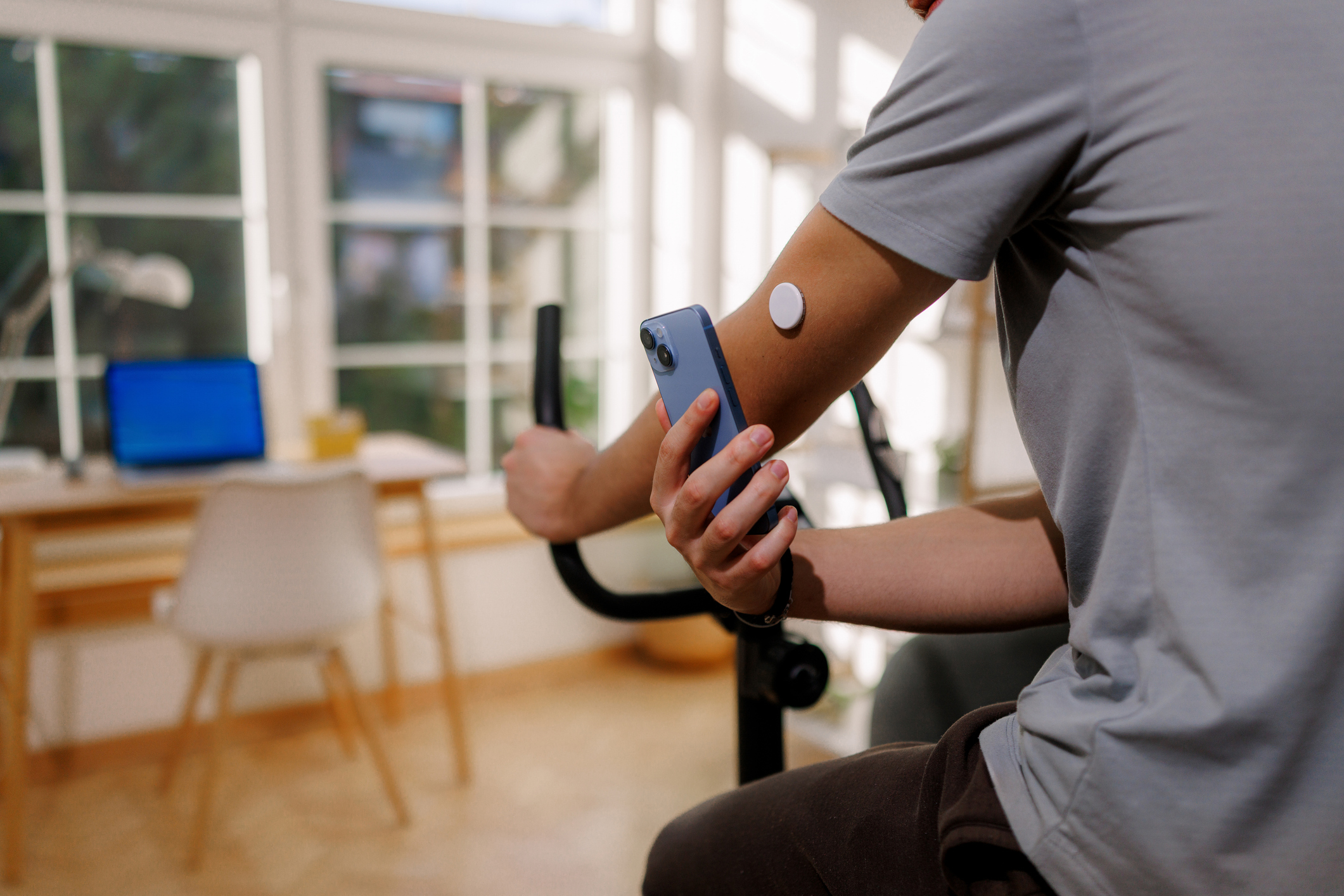 Person checking their CGM sensor.