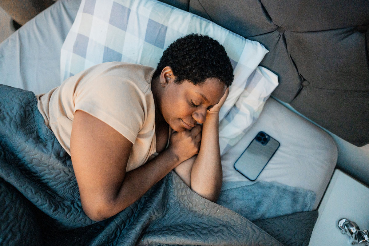woman sleeping with her phone