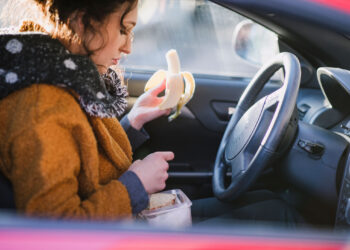 Woman eating in her car