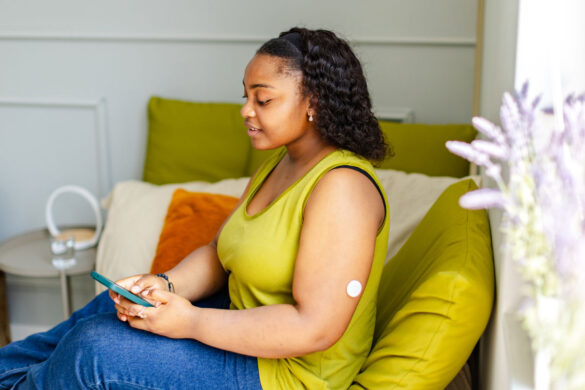 Woman on couch using phone