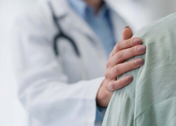 Image of clinician resting hand on a patients shoulder