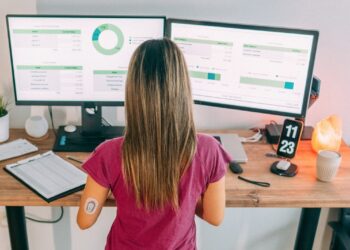 Woman checking CGM metrics on computer