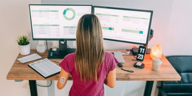 Woman checking CGM metrics on computer